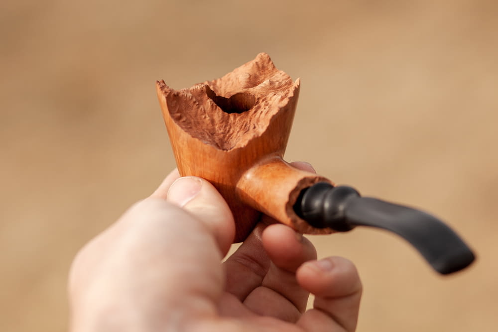 brown and black tobacco pipe