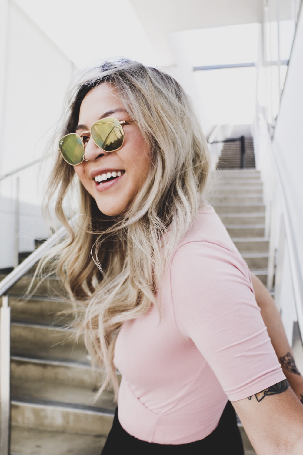 woman smiling and wearing sunglasses