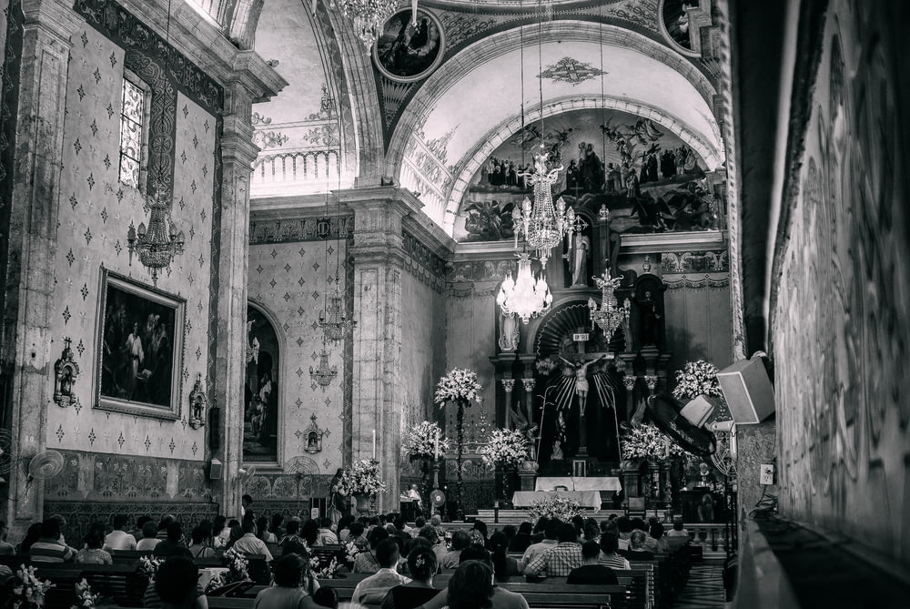 a black and white photo of a church filled with people