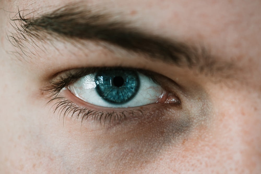 selective focus photography of person's eye