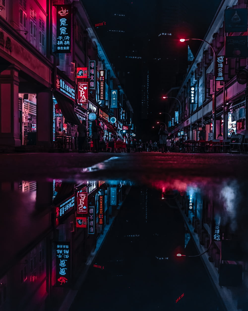 nasse Straße zwischen den Gebäuden in der Nacht