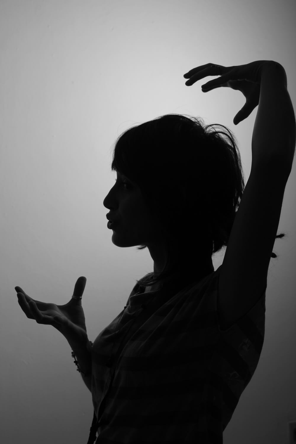 woman raising left and right hands
