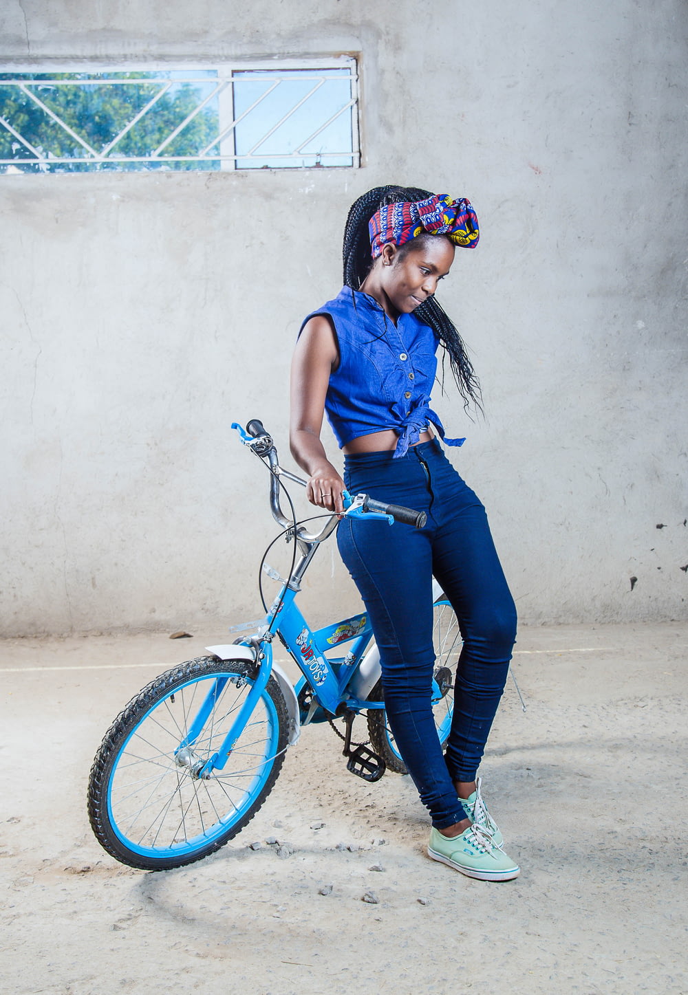 woman sitting on blue bicycle