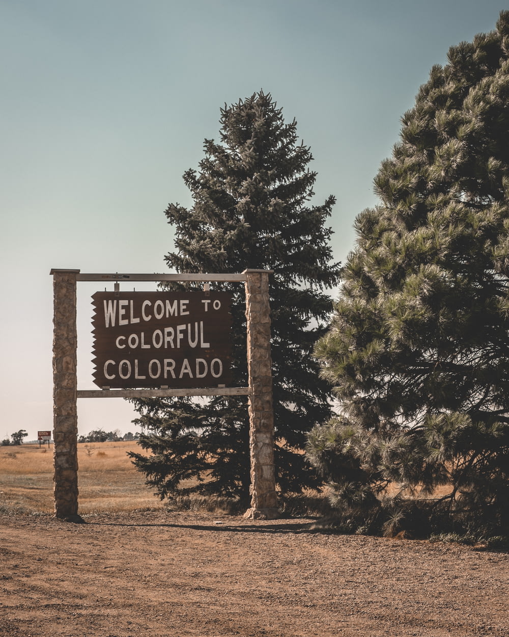 welcome to colorful Colorado signage beside trees
