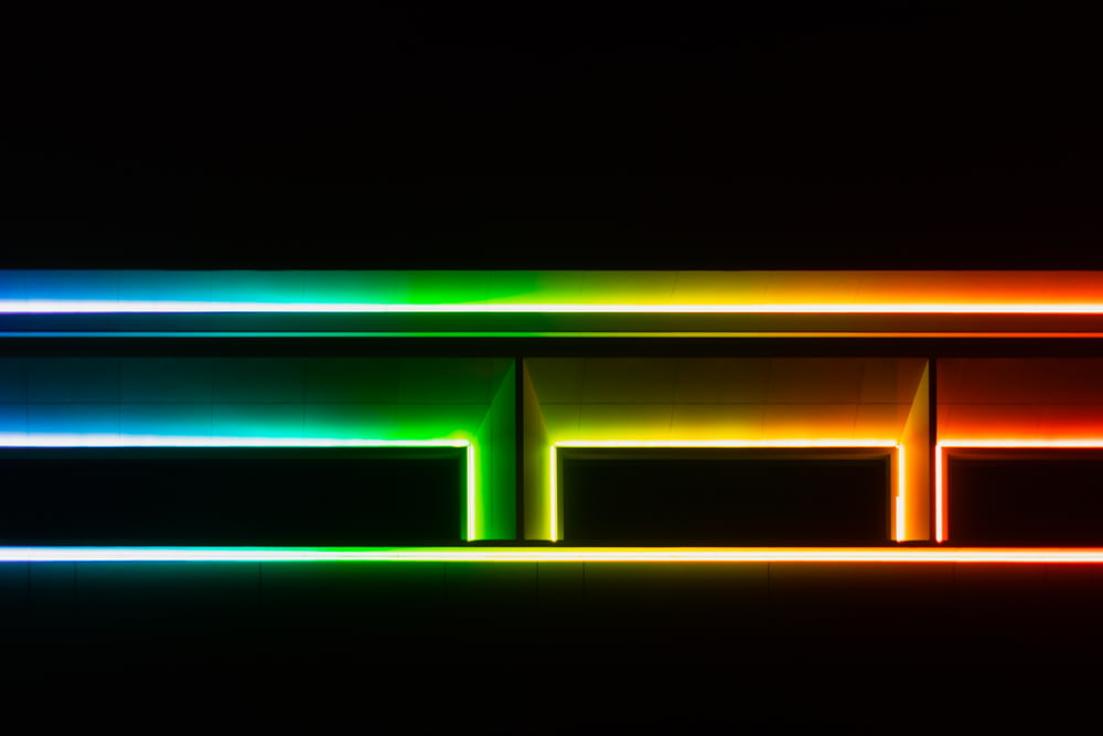 a multicolored shelf is lit up in the dark