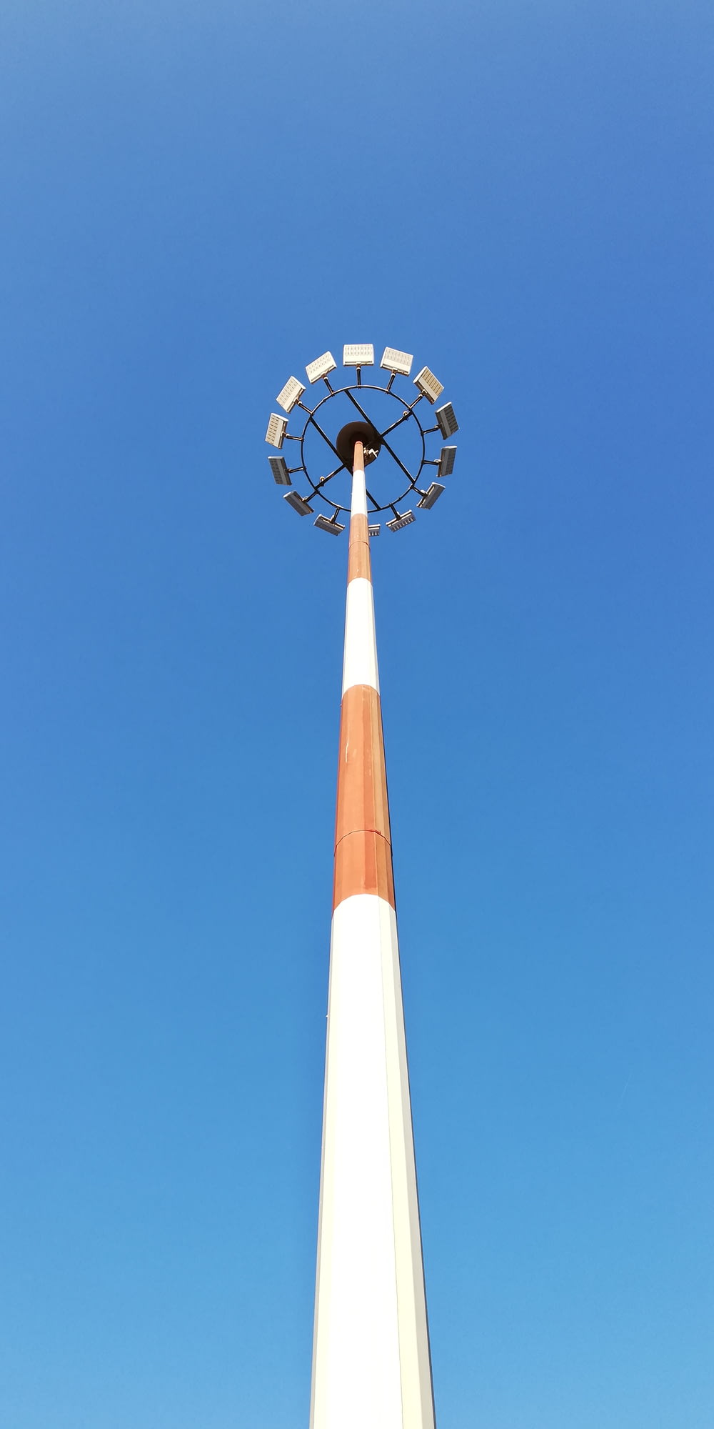 white and red steel tower during daytime