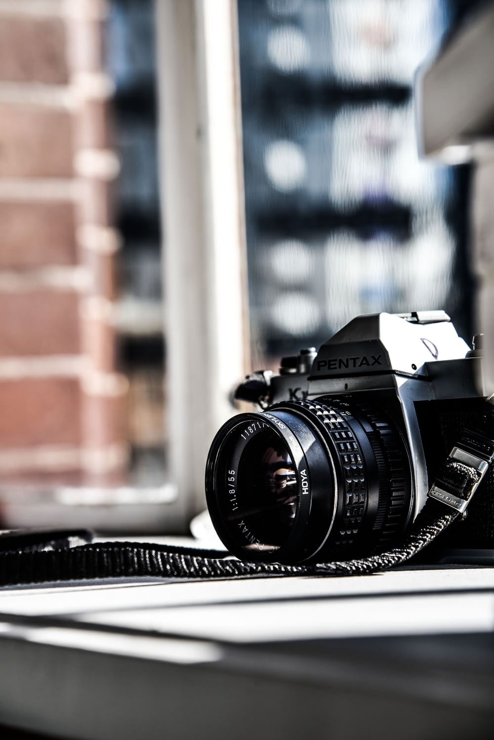 black and gray Pentax SLR camera