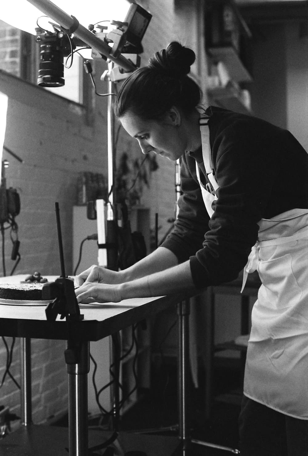 grayscale photography of woman wearing apron