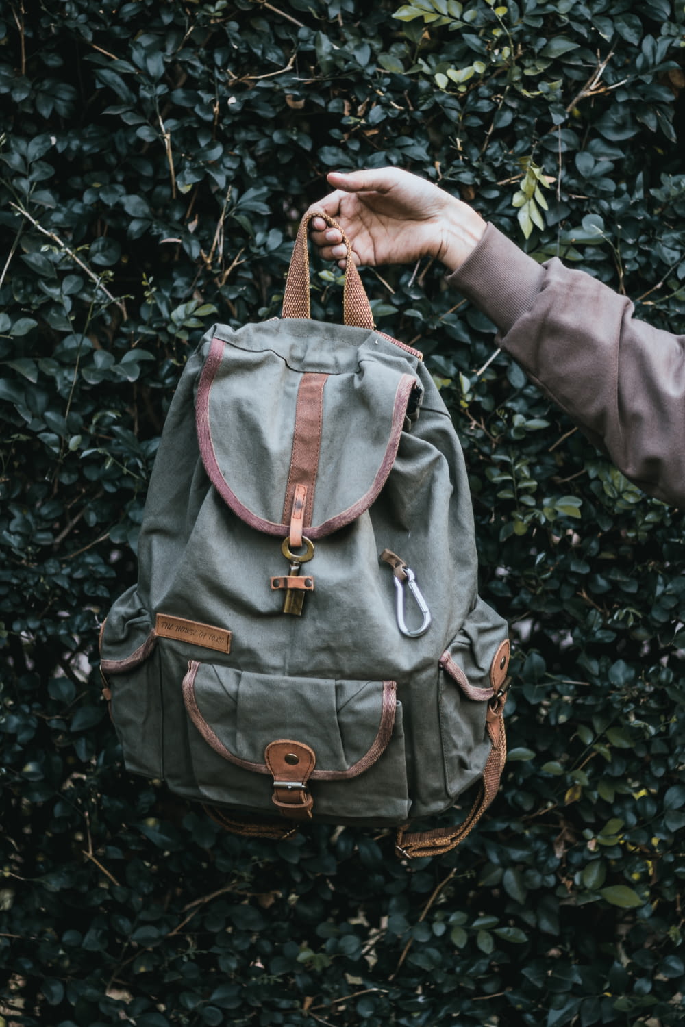 person carryong gray and brown backpack