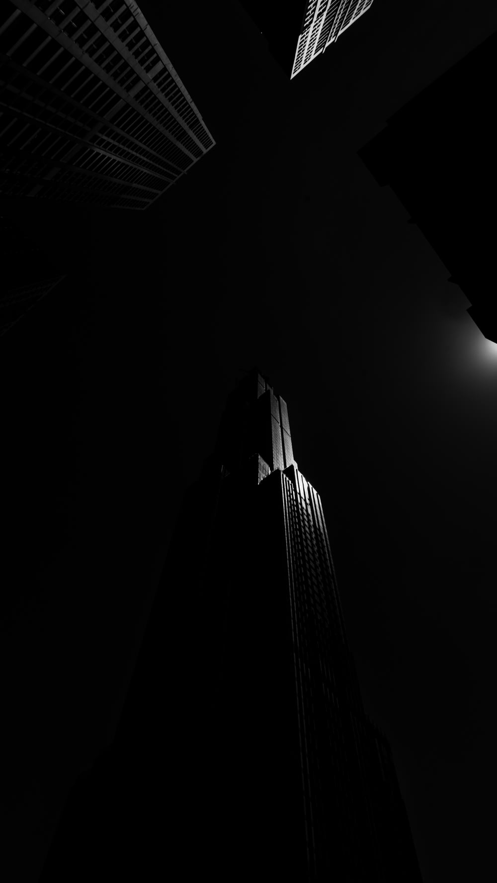 grayscale and low angle photography of high-rise building