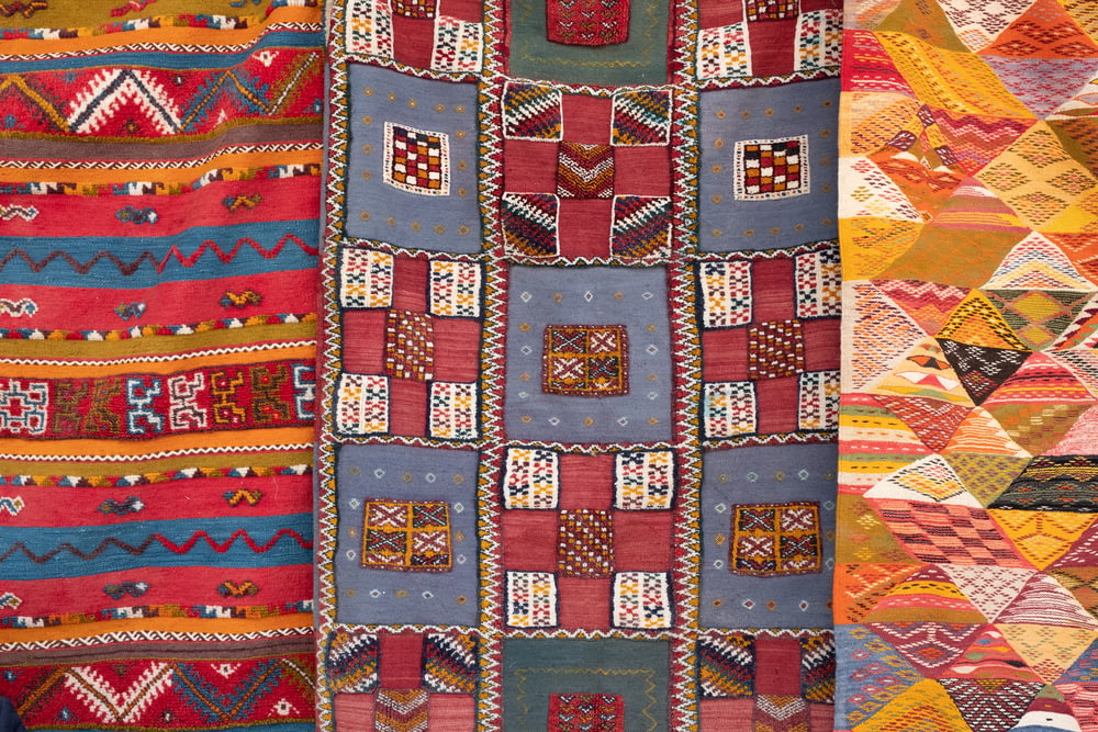 three assorted-color quilts
