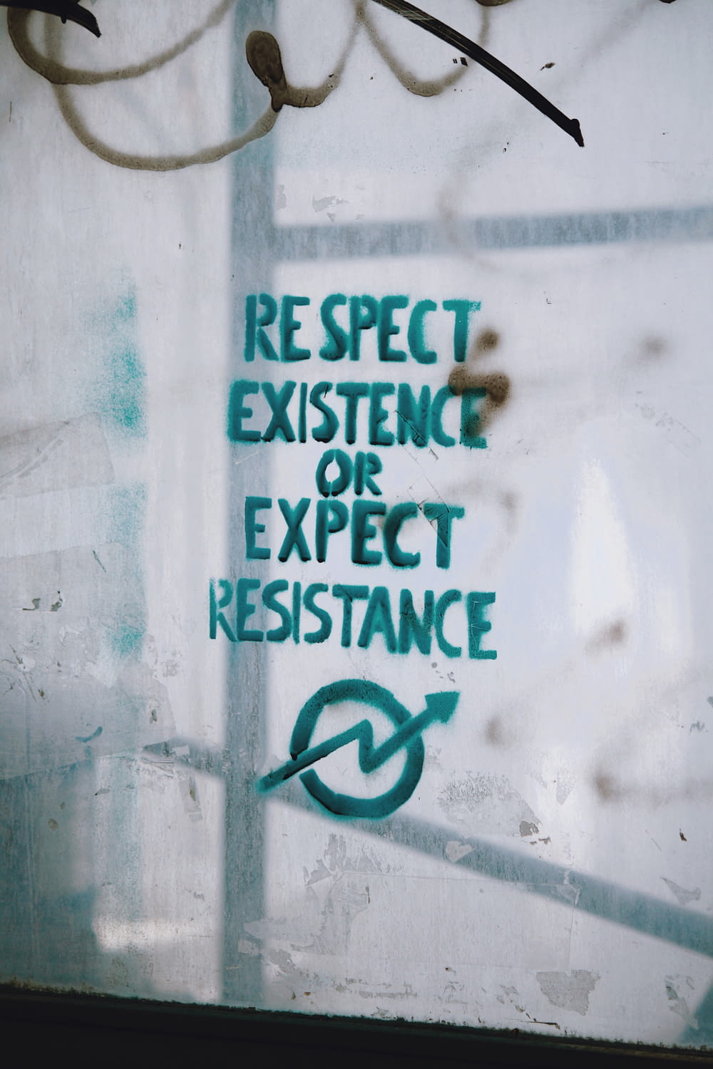 respect existence or expect resistance text on glass board