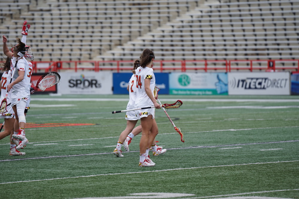 women playing lacrosse at the field