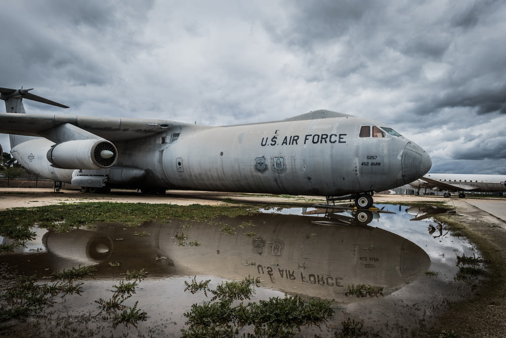 gray US Air Force airplane parked on body of water