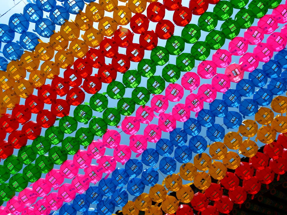 a multicolored array of ribbons with a sky background