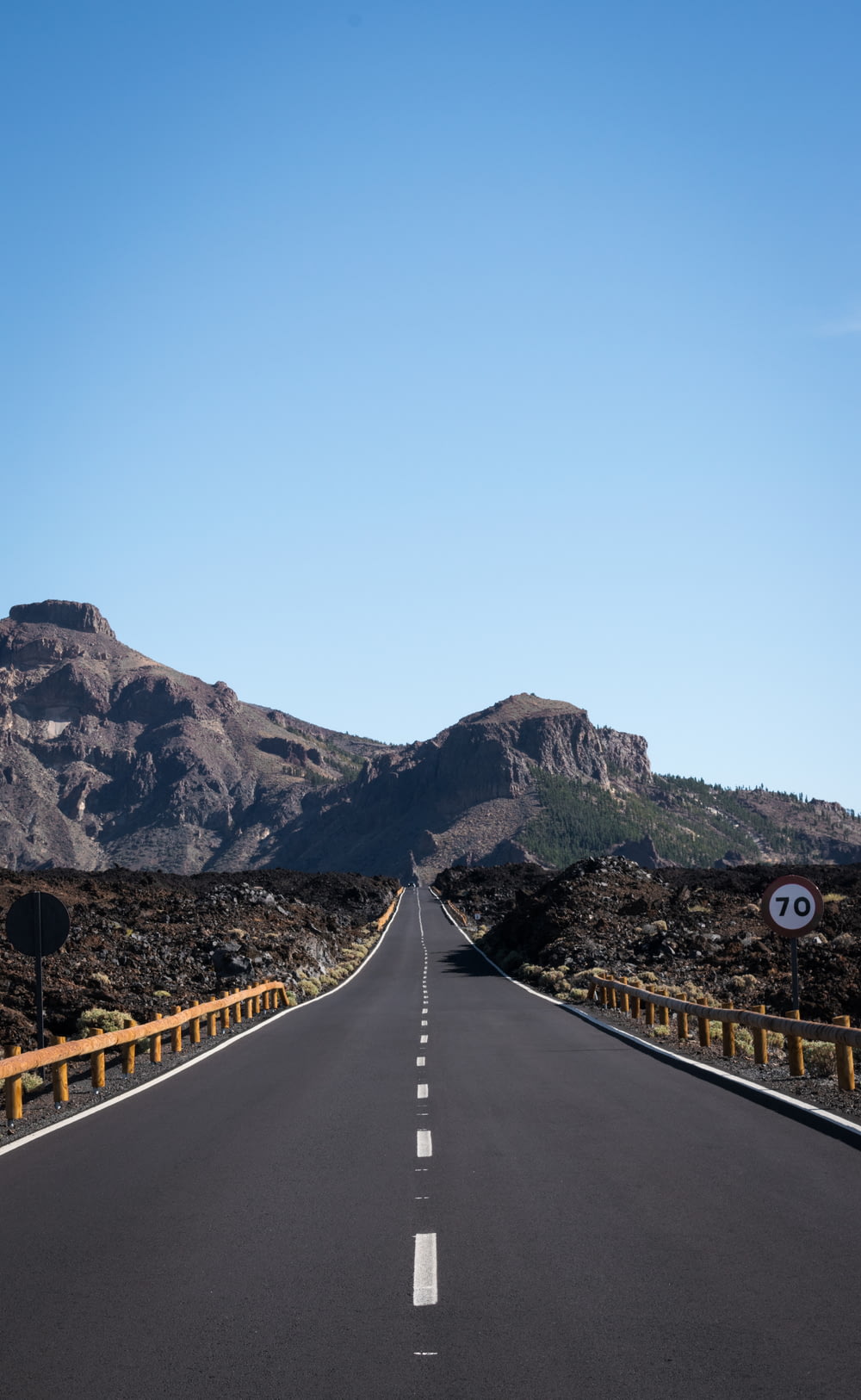 straight asphalt road with mountain background
