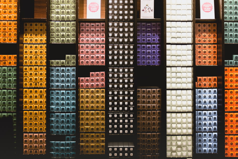 a wall of different colored boxes on display
