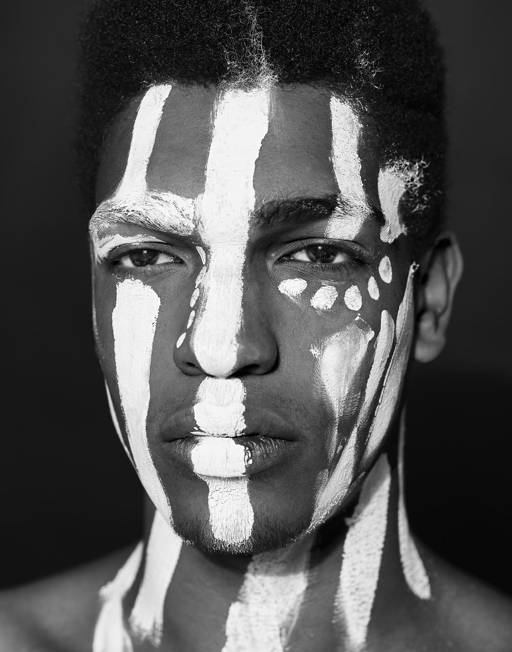 man with white paint on face