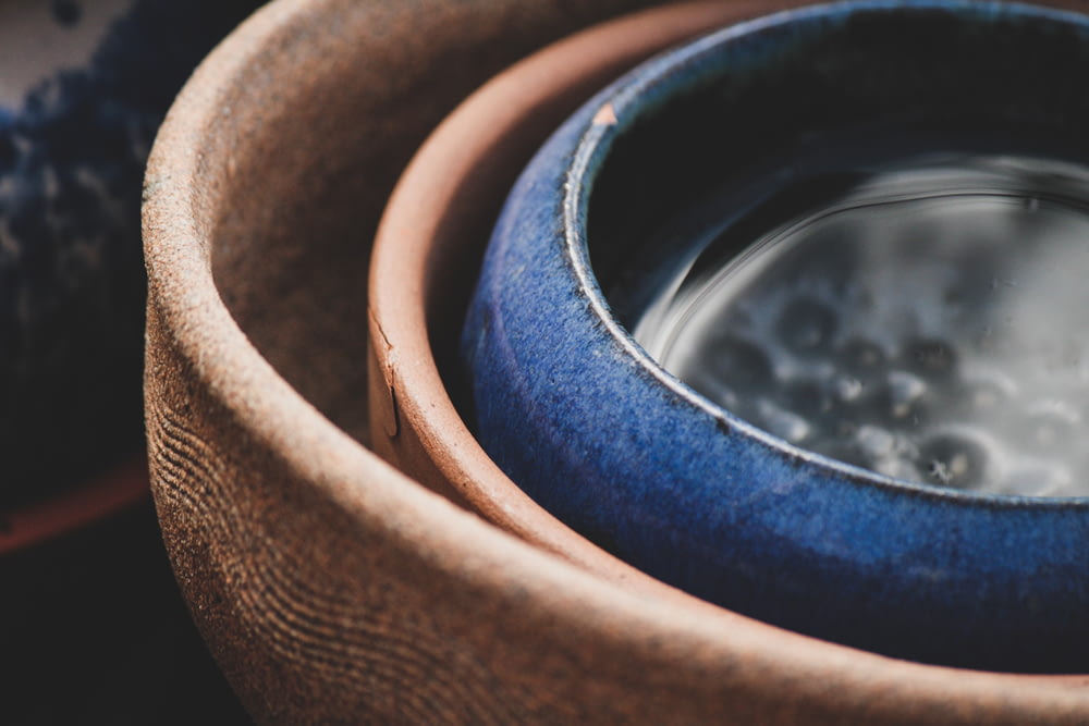 selective focus photography of blue and brown clay pots