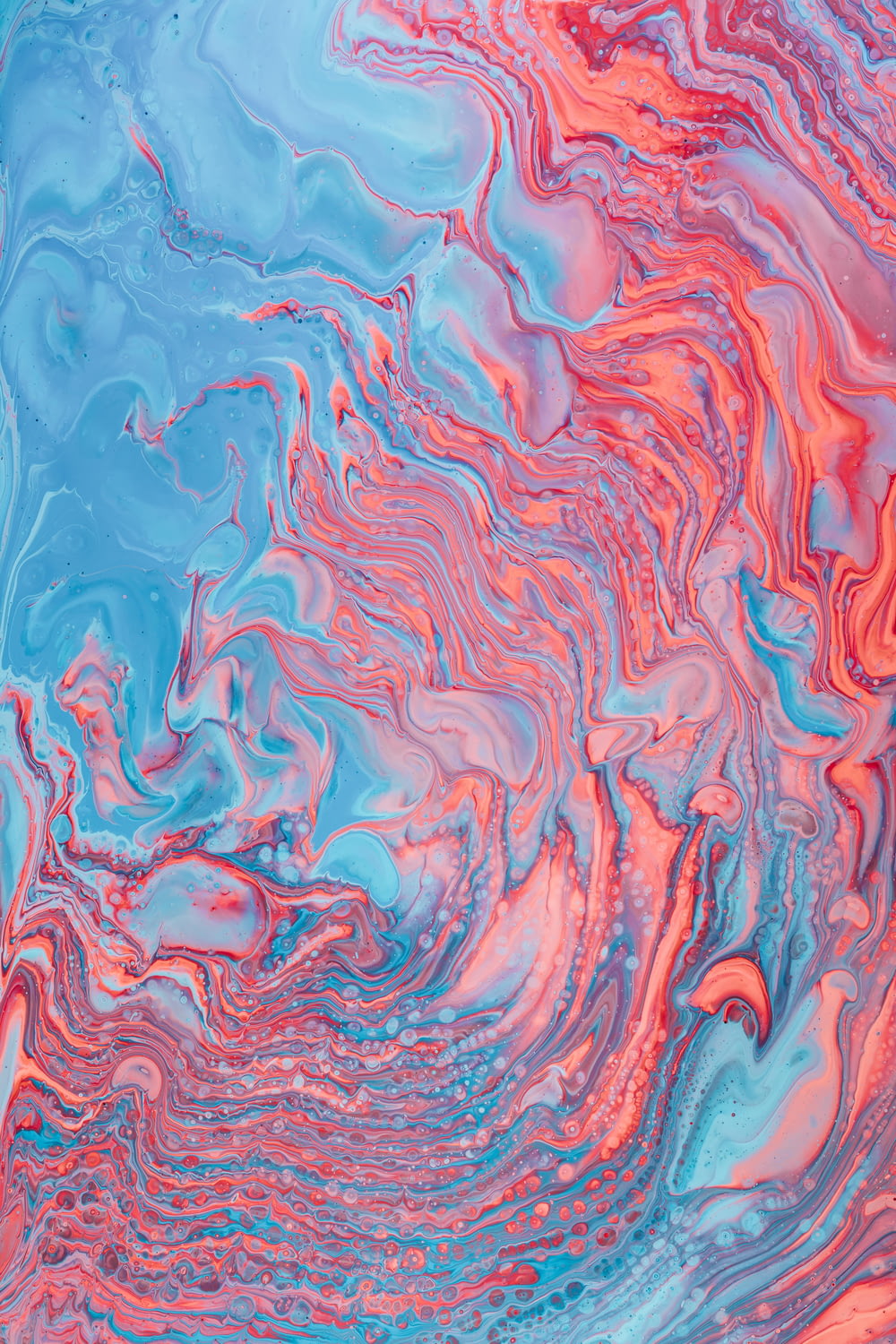 a blue, pink and red liquid swirl background