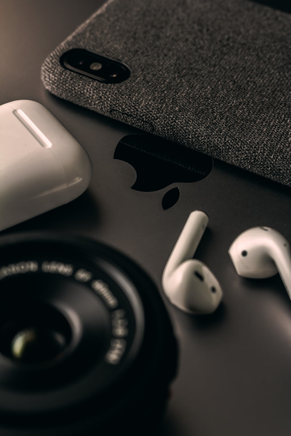 space gray iPhone X beside AirPods