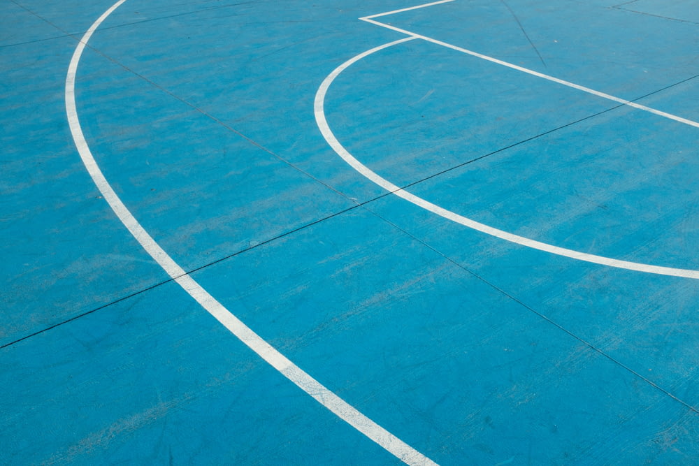 white painted lines on blue court floor