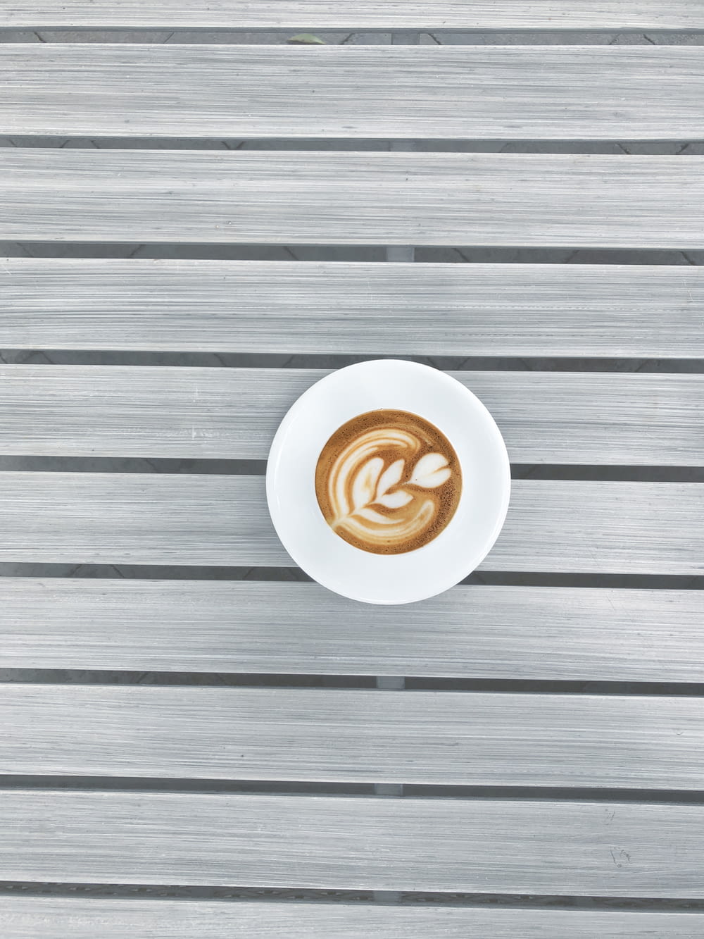 round white espresso coffee on grey striped surface