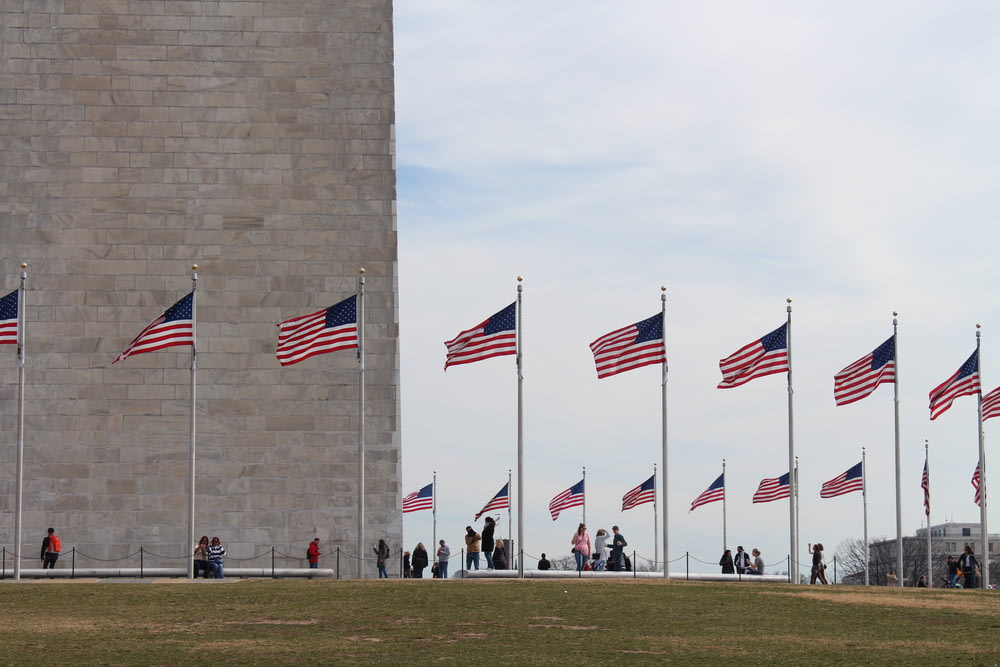 people standing near United States flag