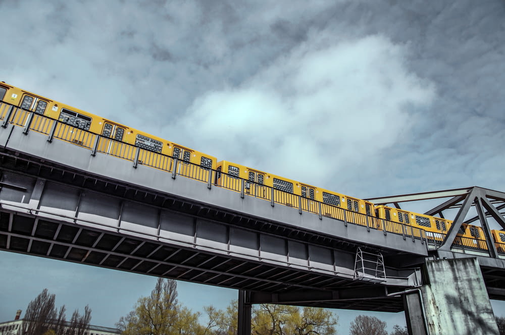 yellow train under gloomy sky