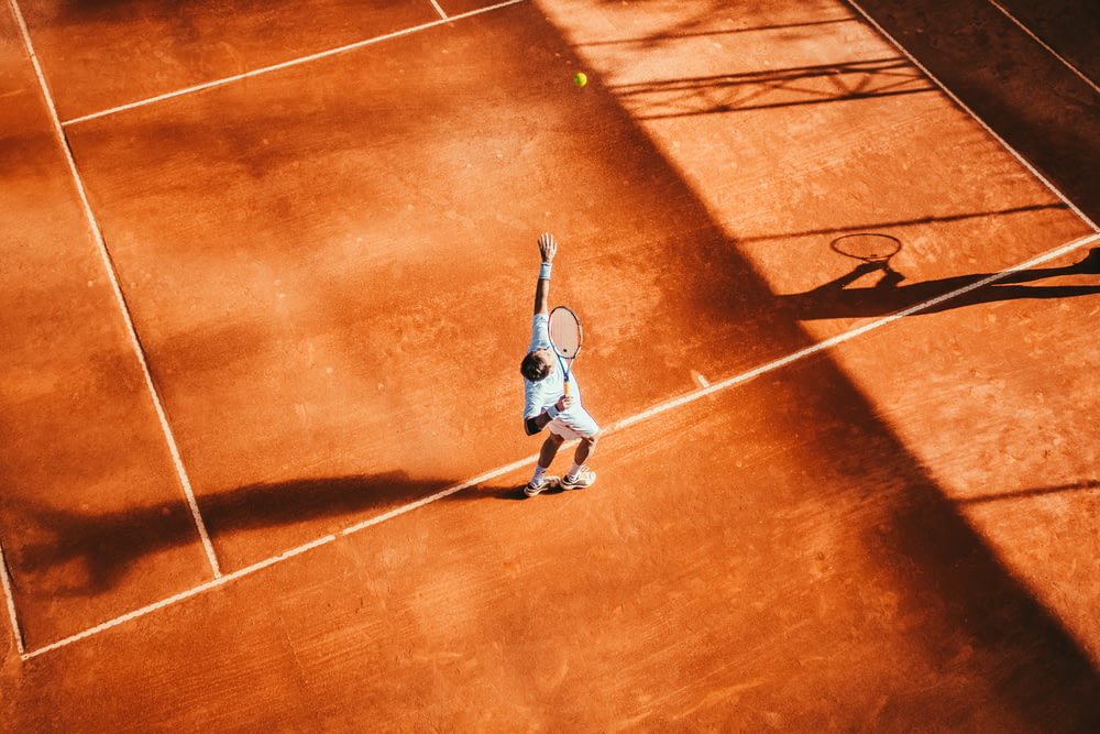 テニスをする男