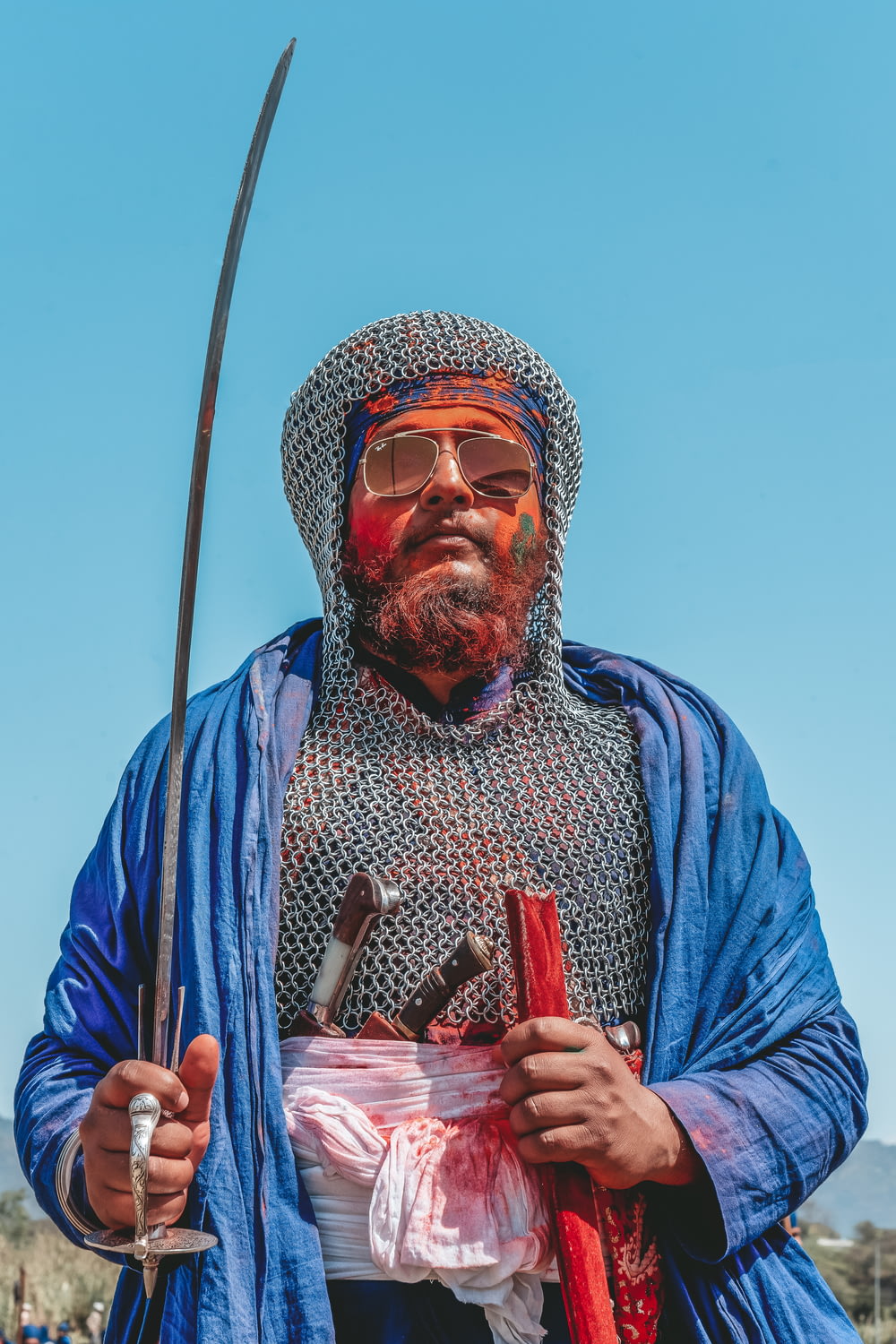 man holding sword with sunglasses