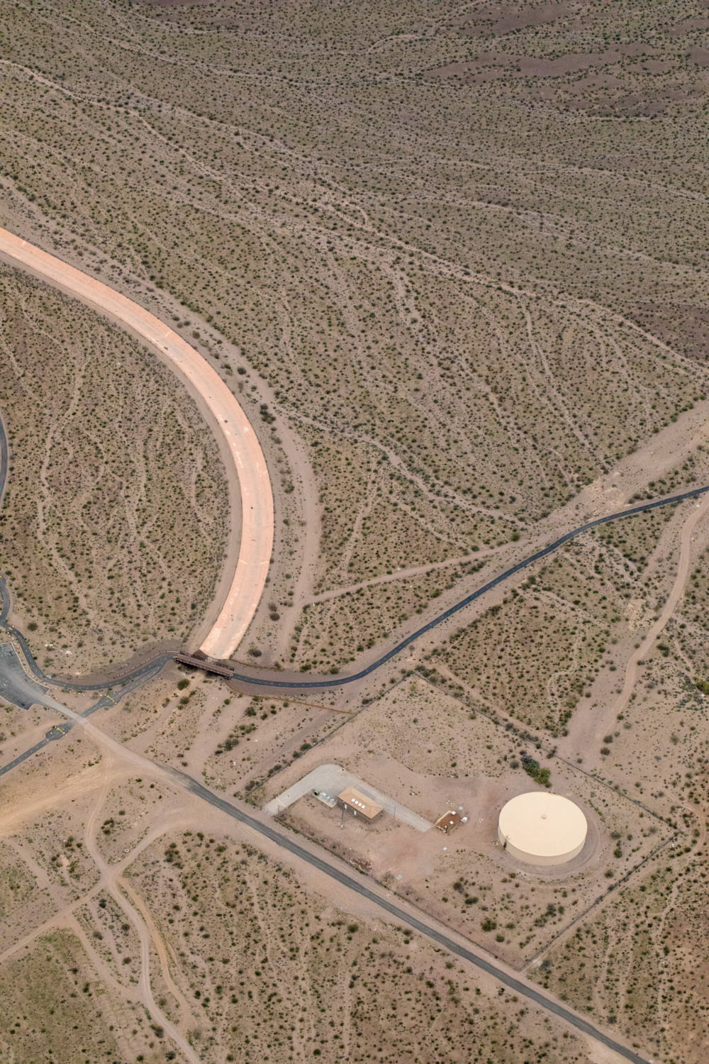 an aerial view of a road in the middle of the desert