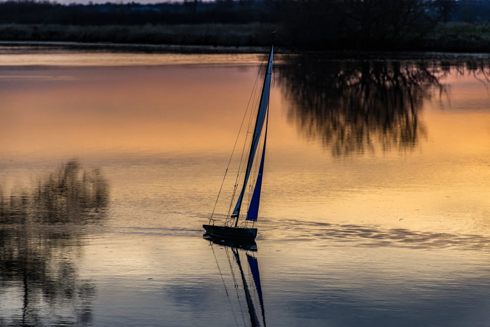 a sailboat in the middle of a lake