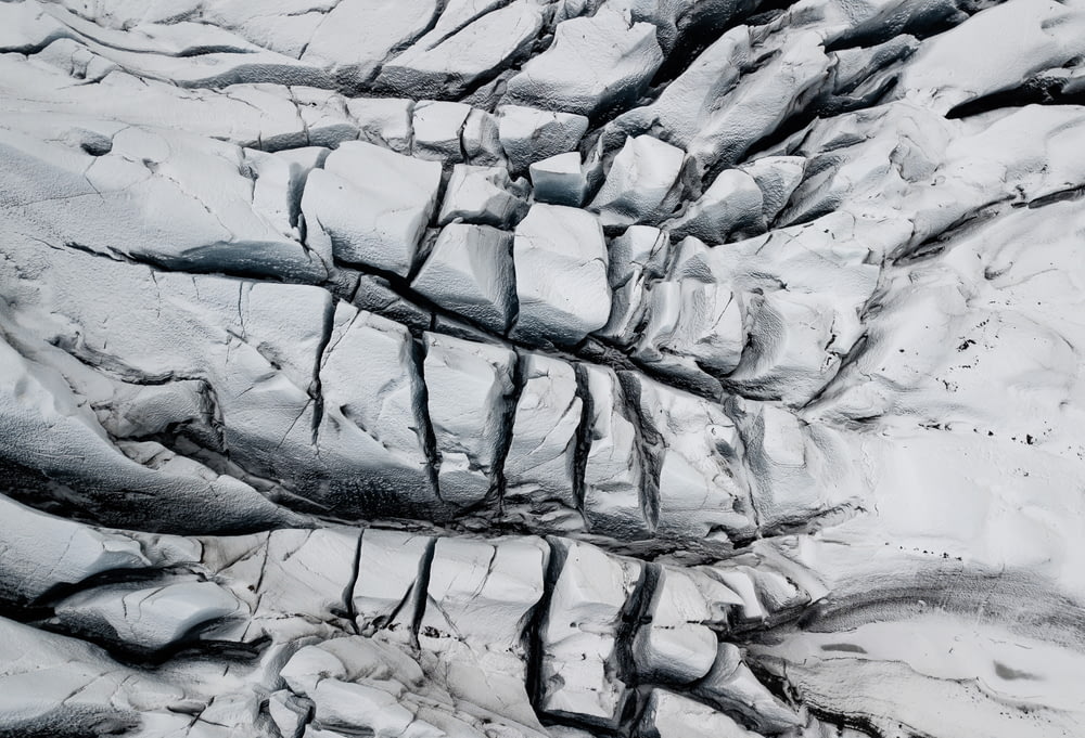 an aerial view of a glacier with a crack in the ice