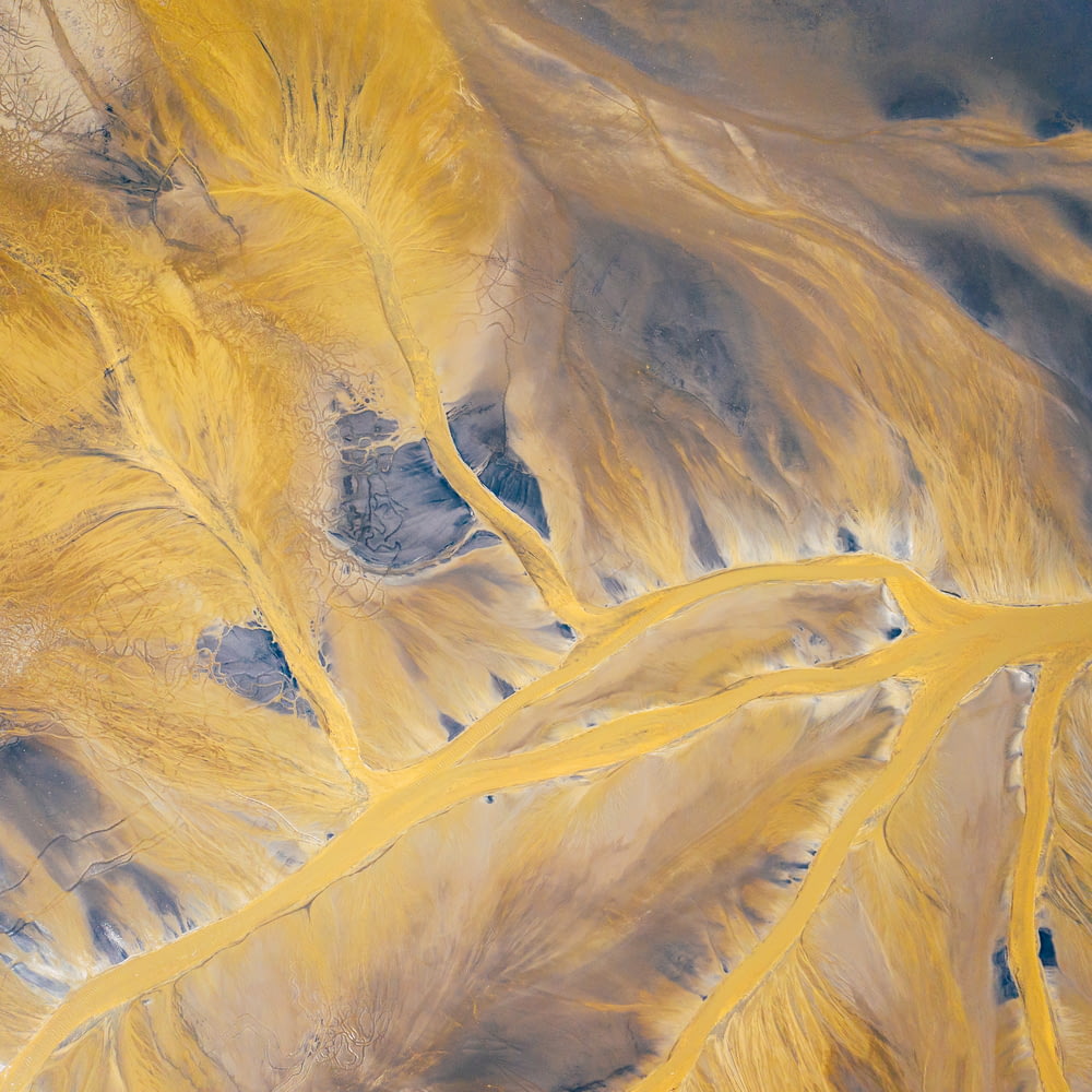 an aerial view of a yellow and brown mountain range