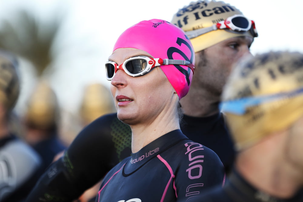 selective focus photography of woman wearing swimming cap
