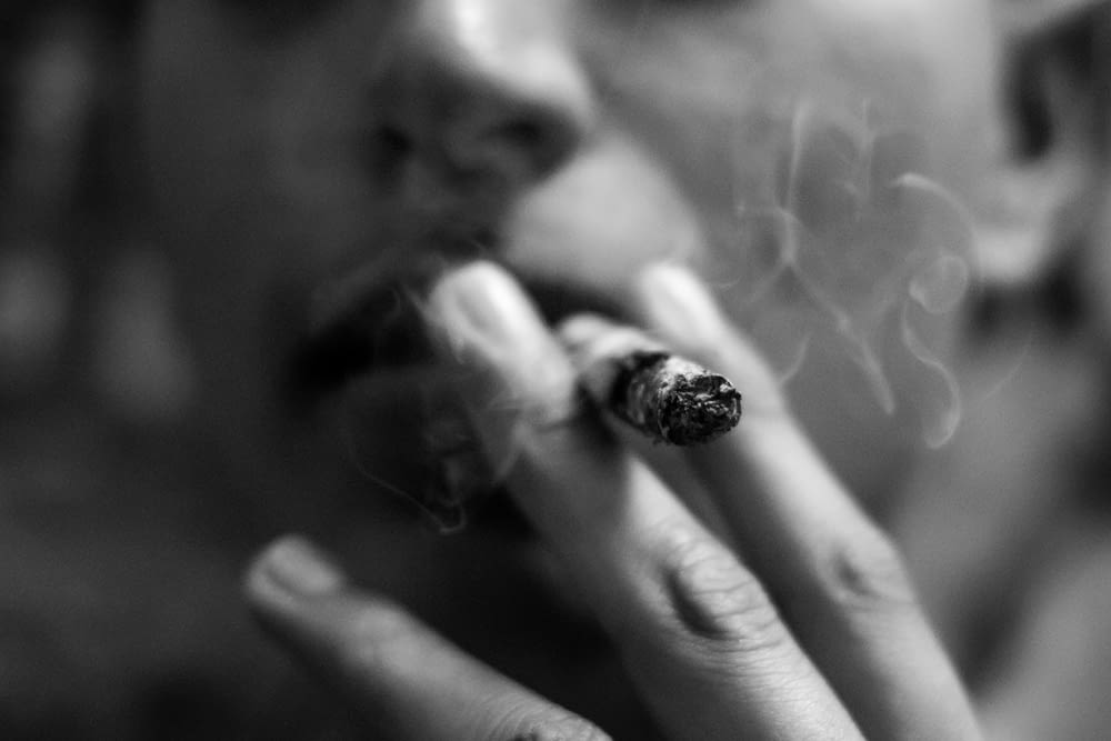 selective photography of smoking man