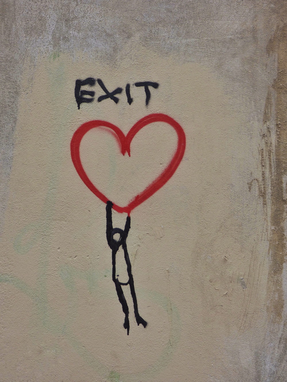 a drawing of a person holding a heart on a wall