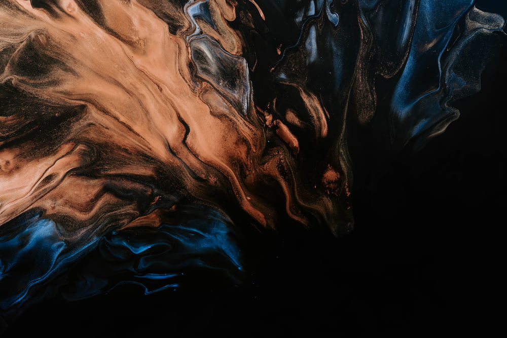 a close up of a black and brown abstract painting