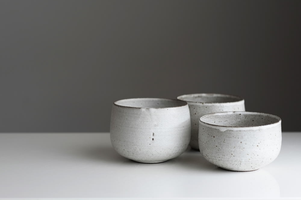a couple of white bowls sitting on top of a table
