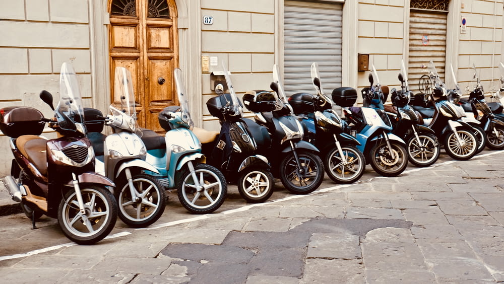 motor scooter lined parking area during daytime