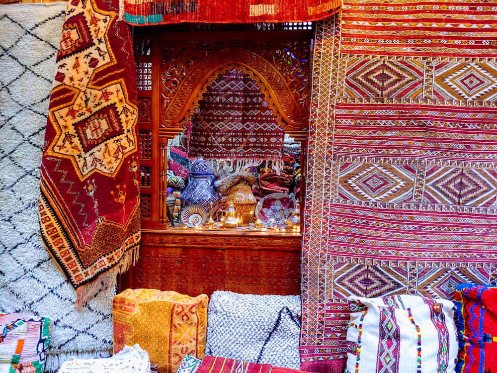 a room filled with lots of different colored rugs