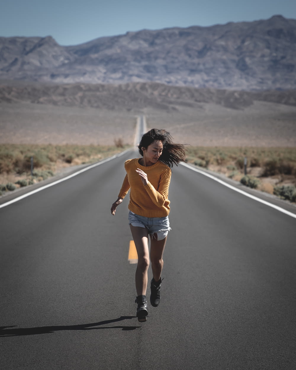 woman running on road during daytime
