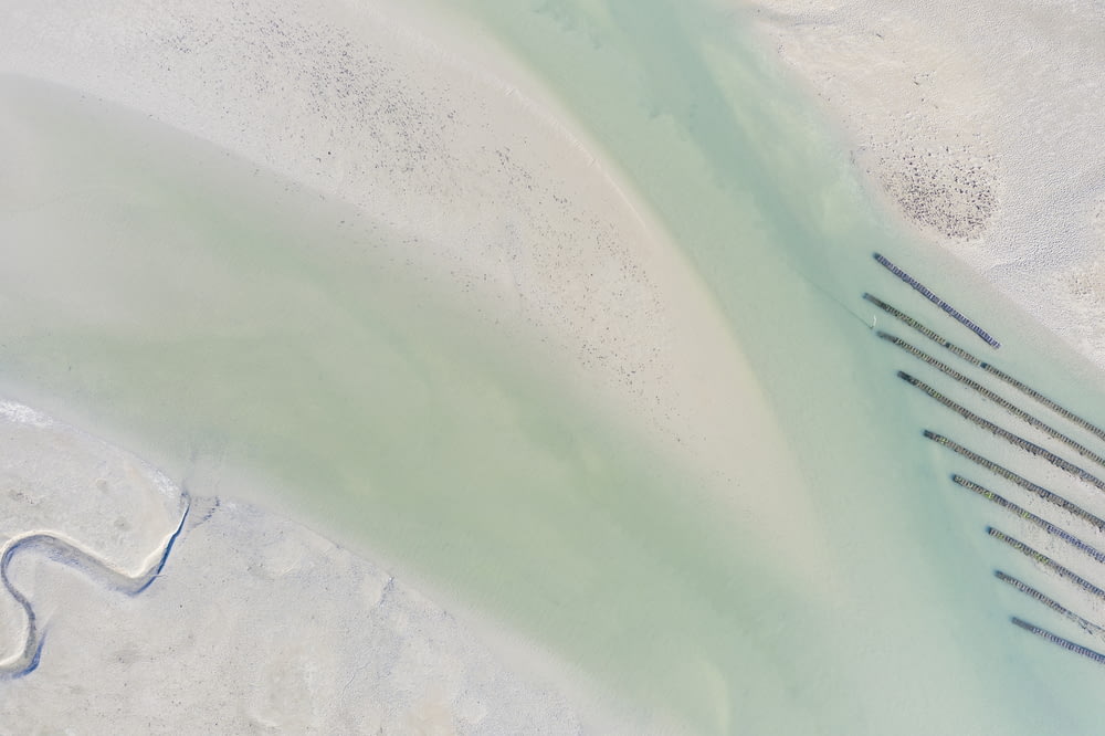 an aerial view of a beach with a bunch of lines in the sand