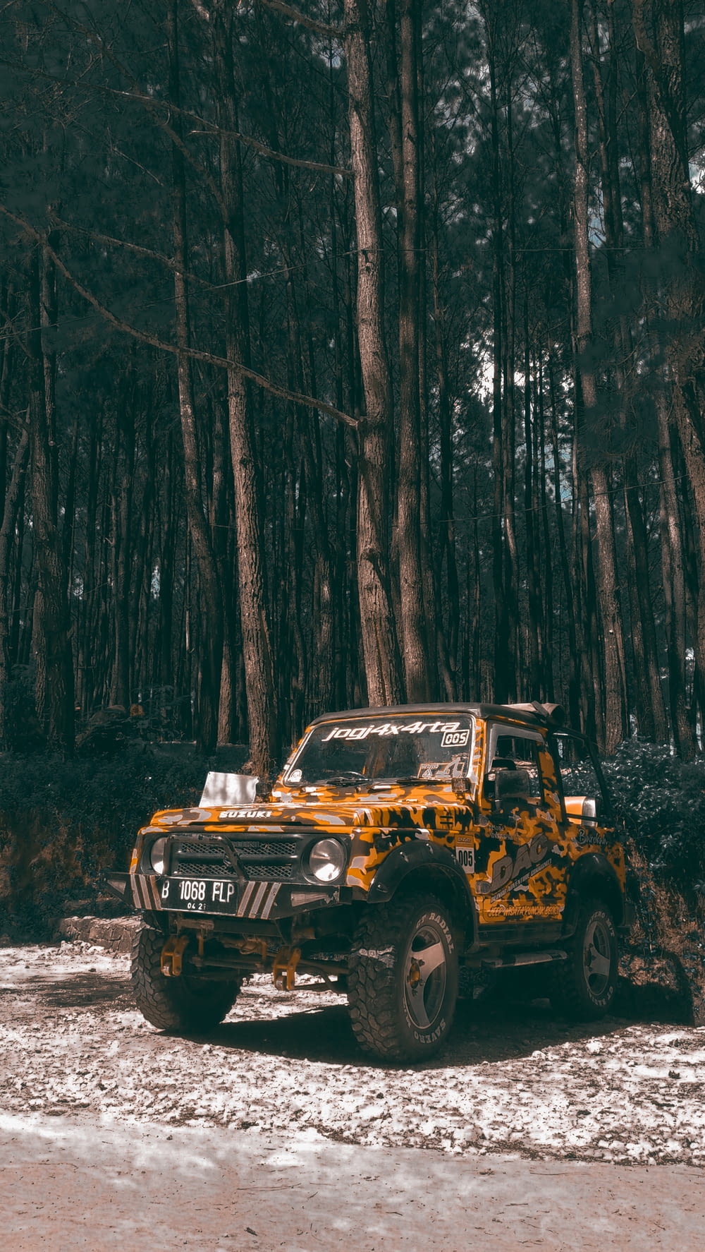 yellow vehicle near trees