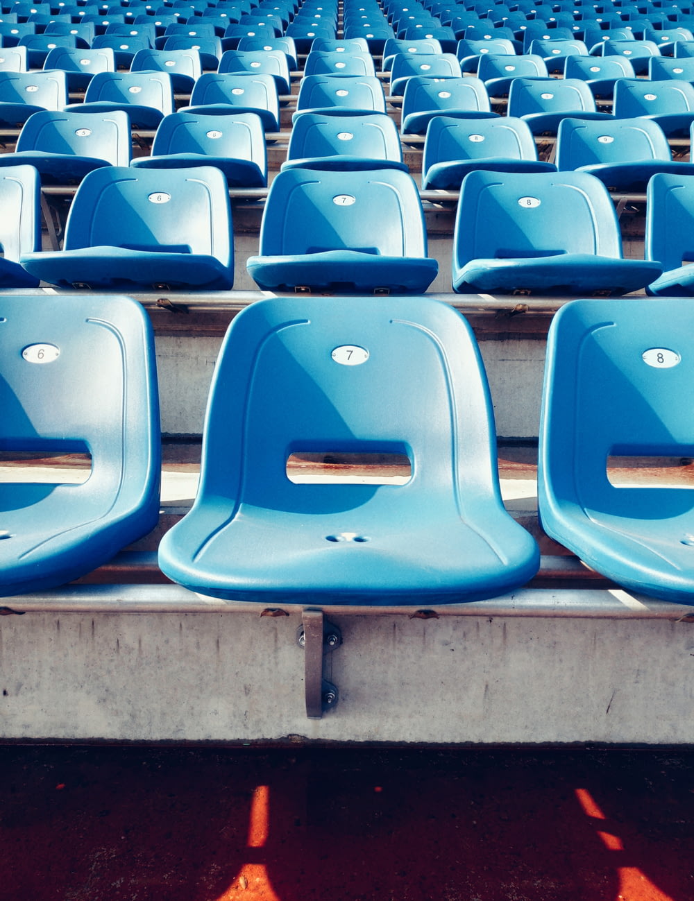 blue plastic chairs at stadium