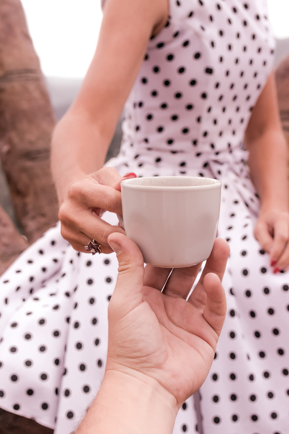 women;s white polka dot dress close-up photography
