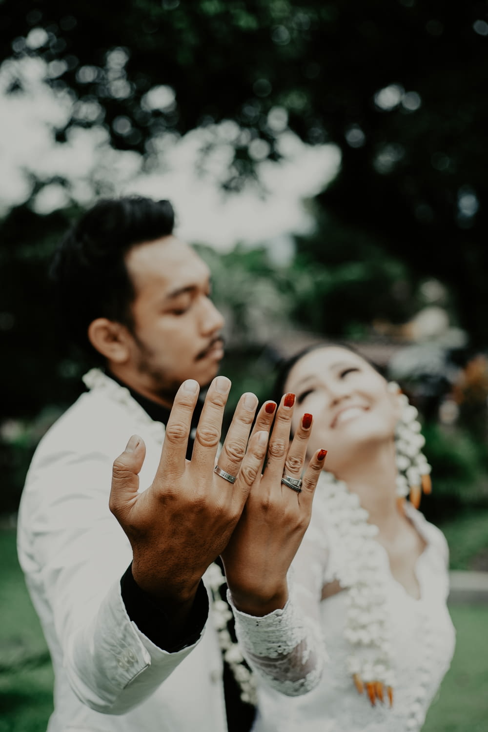 newlywed couples showing wedding bands on ring fingers