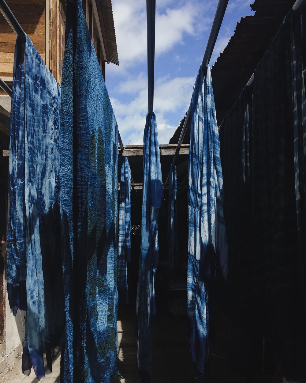 a row of blue towels hanging from a clothes line