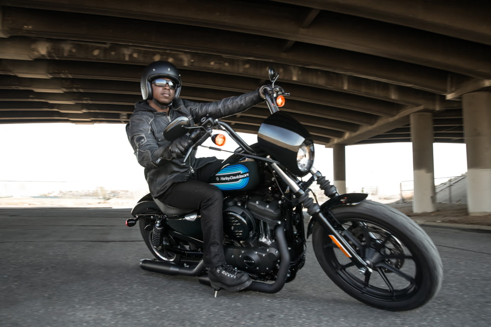 man riding black motorcycle